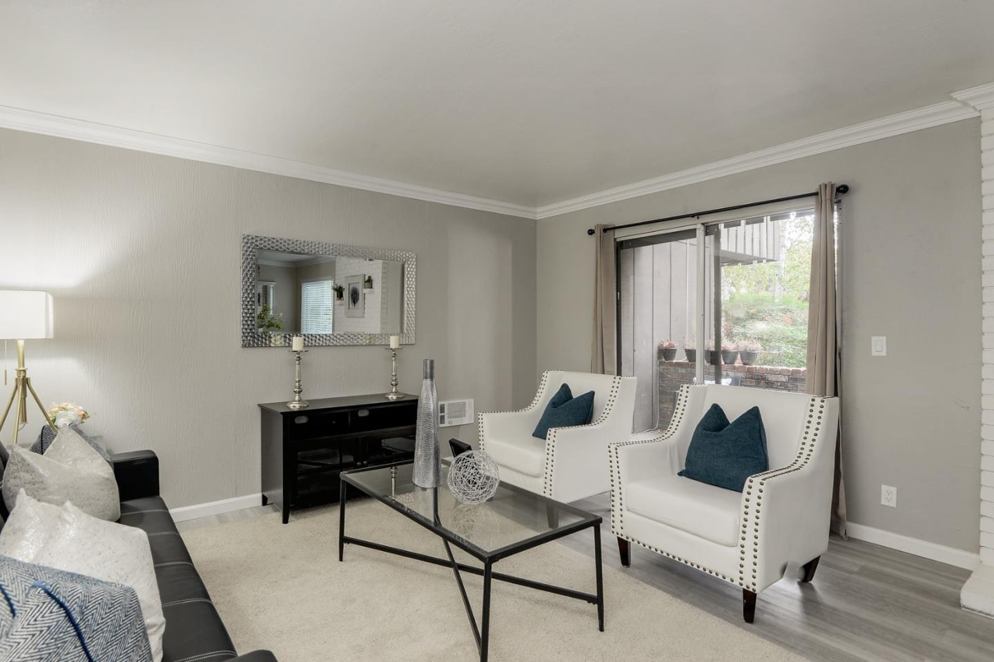 100 East Middlefield Road, Unit 1B Mountain View, CA 94043 - Photo 7 of 18 a living room with furniture and a large window