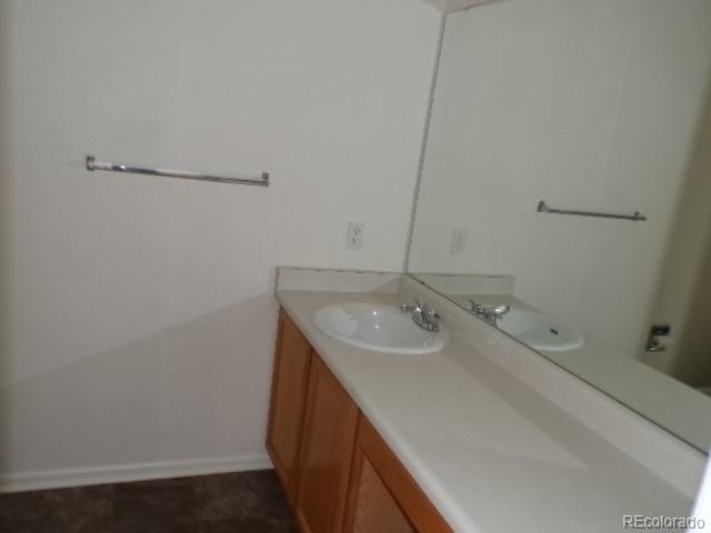 9934 Sydney Lane Highlands Ranch, CO 80130 - Photo 13 of 19 a bathroom with a sink and a mirror