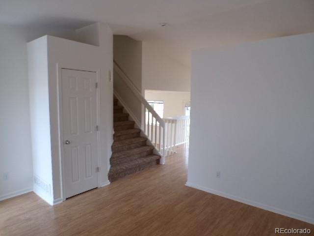 9934 Sydney Lane Highlands Ranch, CO 80130 - Photo 5 of 19 a view of a hallway with wooden floor