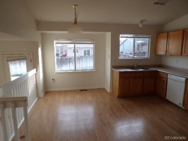 9934 Sydney Lane Highlands Ranch, CO 80130 - Photo 6 of 19 an empty room with wooden floor and windows
