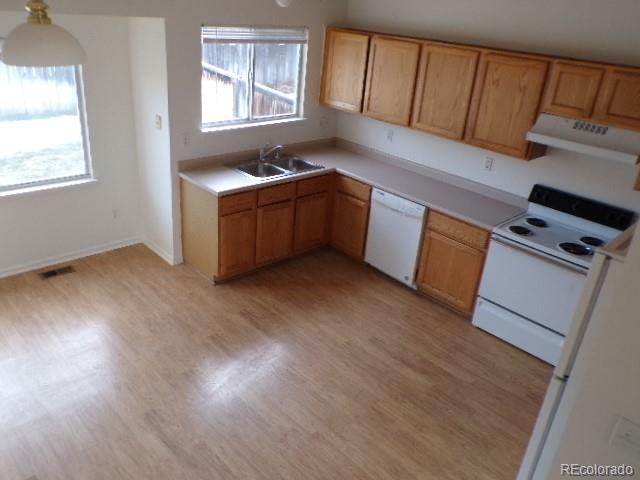 9934 Sydney Lane Highlands Ranch, CO 80130 - Photo 7 of 19 a kitchen with sink cabinets and wooden floor