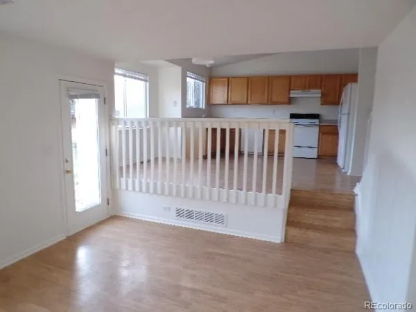 a view of kitchen with cabinets and window