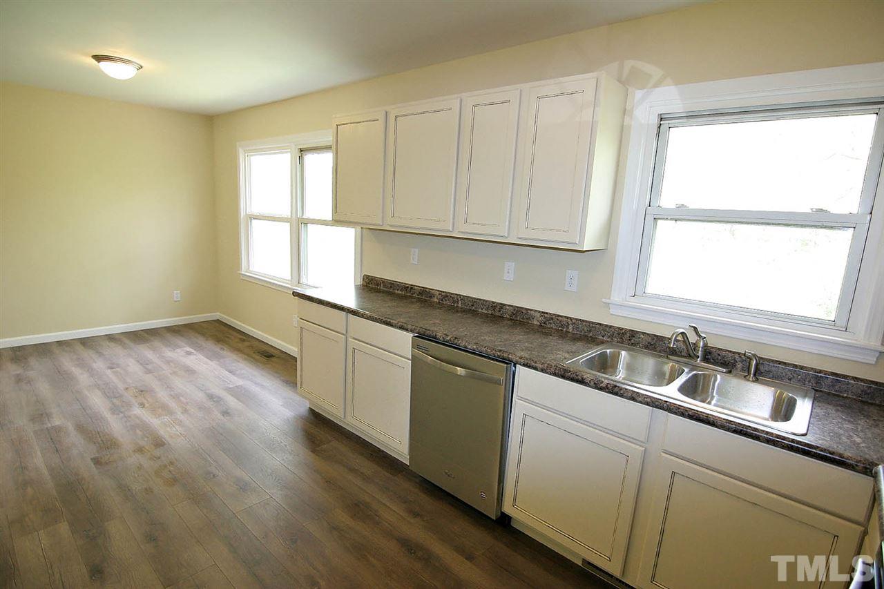 7033 Buck Road Wendell, NC 27591 - Photo 11 of 25 a kitchen with granite countertop cabinets stainless steel appliances a sink and a window