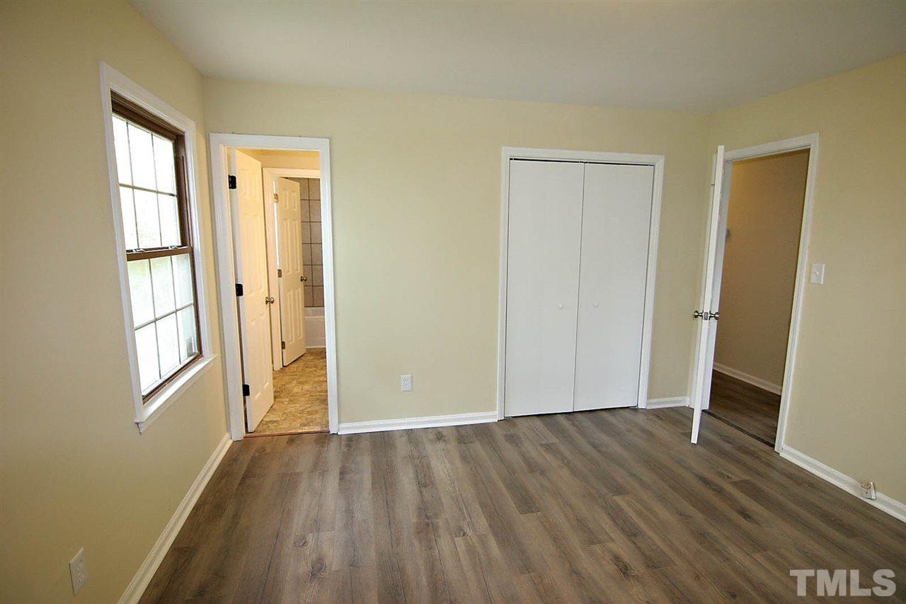 7033 Buck Road Wendell, NC 27591 - Photo 18 of 25 an empty room with wooden floor and windows