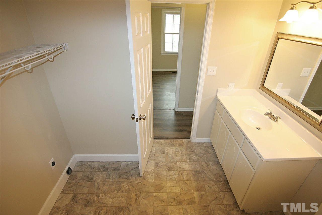 7033 Buck Road Wendell, NC 27591 - Photo 22 of 25 a bathroom with a tub sink and vanity