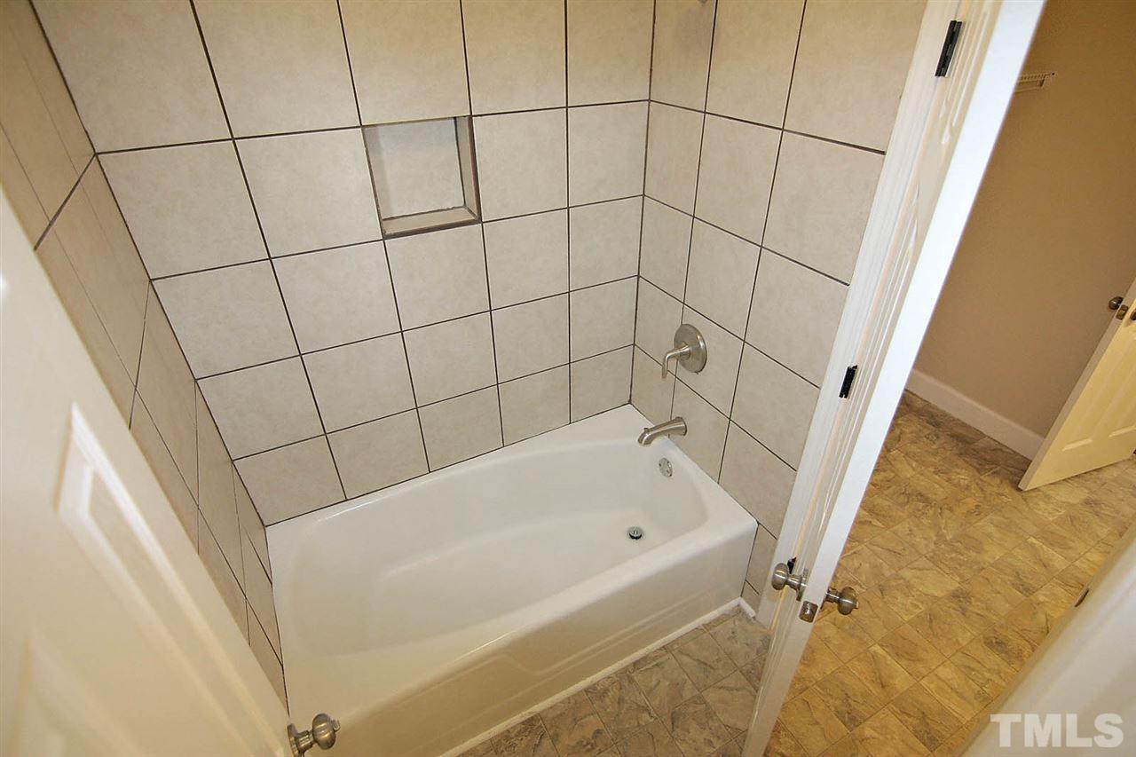 7033 Buck Road Wendell, NC 27591 - Photo 23 of 25 a bathroom with a bathtub