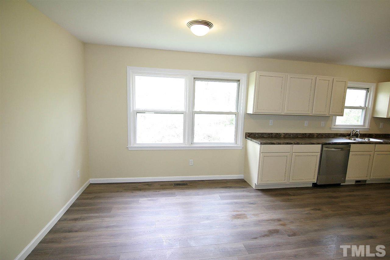 7033 Buck Road Wendell, NC 27591 - Photo 6 of 25 a view of a kitchen with wooden floor and a window