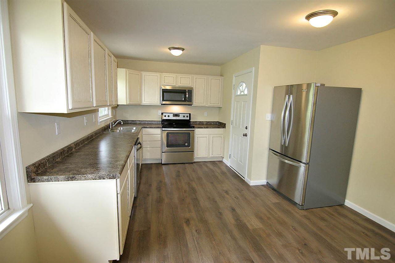 7033 Buck Road Wendell, NC 27591 - Photo 10 of 25 a kitchen with granite countertop a refrigerator and a sink