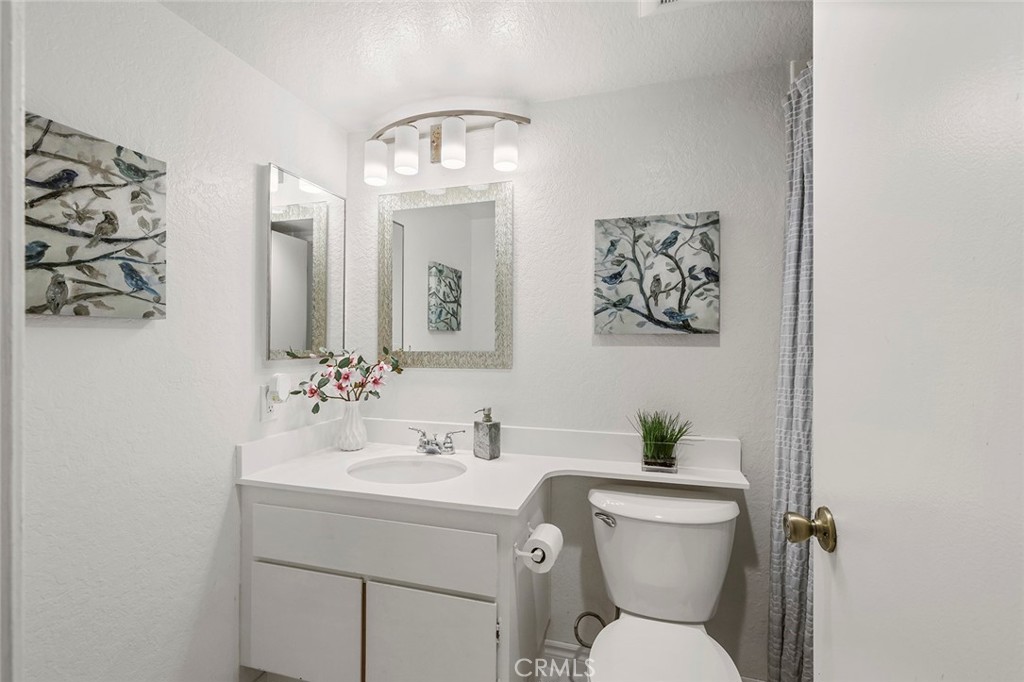 20702 El Toro Road, Unit 226 Lake Forest, CA 92630 - Photo 13 of 39 a bathroom with a toilet sink and mirror