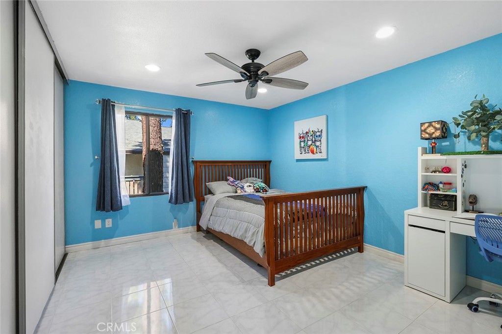 20702 El Toro Road, Unit 226 Lake Forest, CA 92630 - Photo 16 of 39 a bedroom with a bed and a chandelier