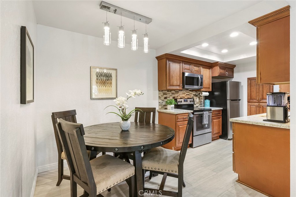 20702 El Toro Road, Unit 226 Lake Forest, CA 92630 - Photo 3 of 39 a kitchen with a dining table and chairs