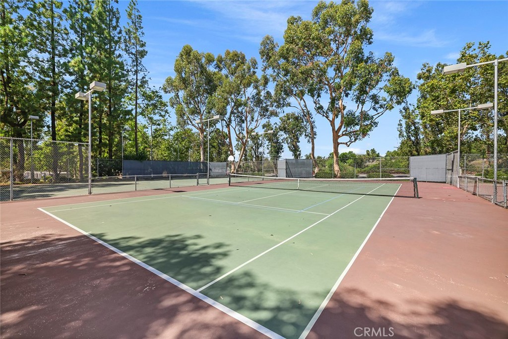 20702 El Toro Road, Unit 226 Lake Forest, CA 92630 - Photo 34 of 39 a view of a tennis ground with large trees