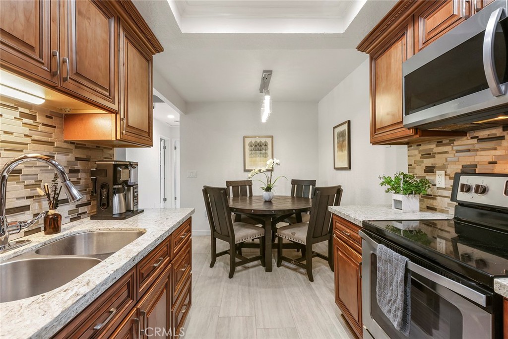 20702 El Toro Road, Unit 226 Lake Forest, CA 92630 - Photo 4 of 39 a kitchen with granite countertop lots of counter top space and dining table