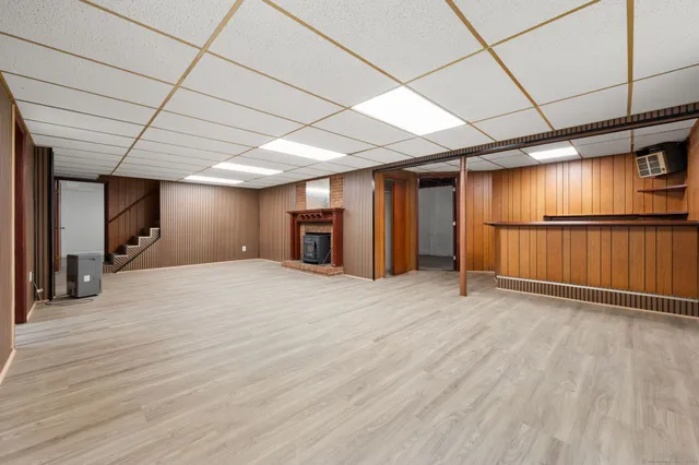 a view of a kitchen with wooden floor and electronic appliances