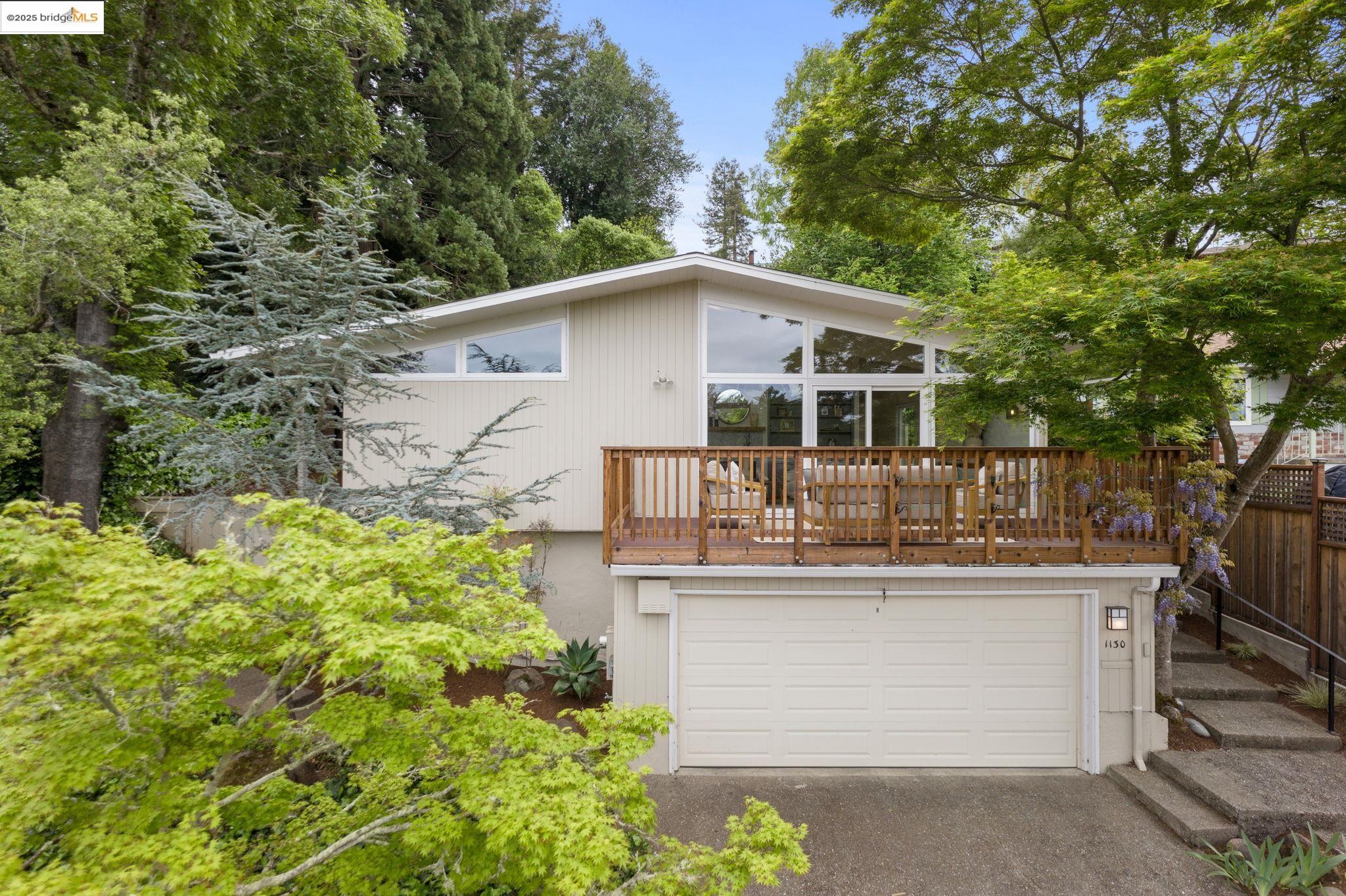 a front view of a house with a garden and plants