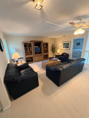 a living room with furniture rug and a lamp