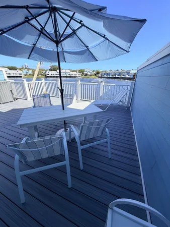 a view of a balcony with chair and wooden floor