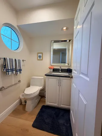 a large kitchen with kitchen island a sink stainless steel appliances and cabinets