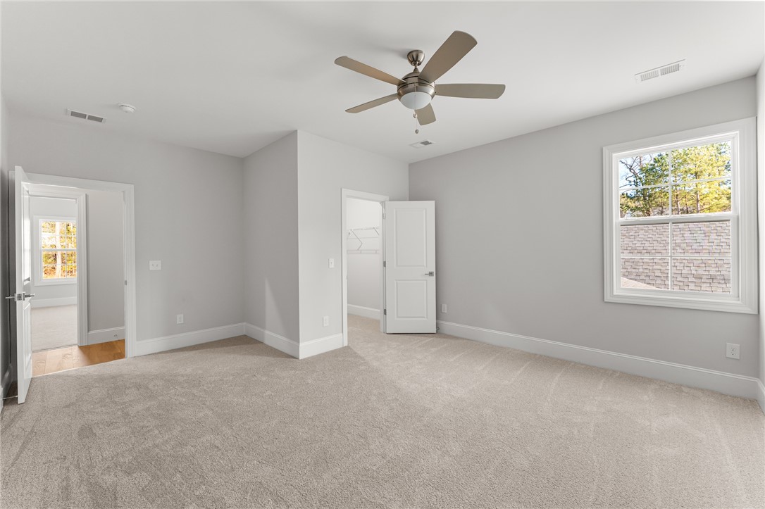 141 Rickys Path Easley, SC 29642 - Photo 37 of 40 This spacious bedroom offers ample natural light and a comfortable, inviting atmosphere.
