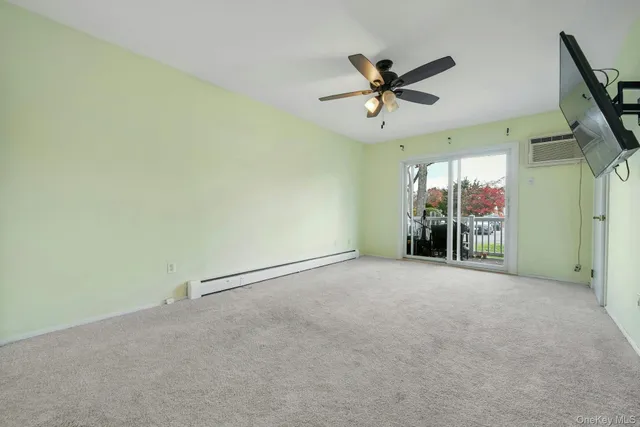 a view of a livingroom with a ceiling fan and window