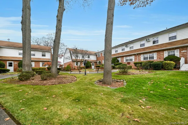 a view of a house with a yard and sitting area