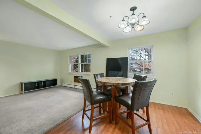 a view of a dining room with furniture wooden floor and a chandelier