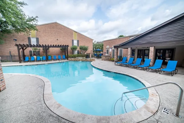 a view of a chairs and table in the patio with a backyard