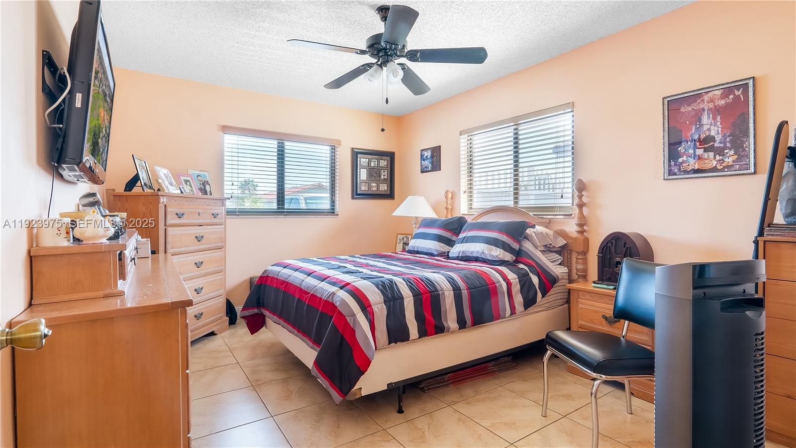 2549 West 72nd Place Hialeah, FL 33016 - Photo 18 of 46 a bed room with a bed and a chandelier