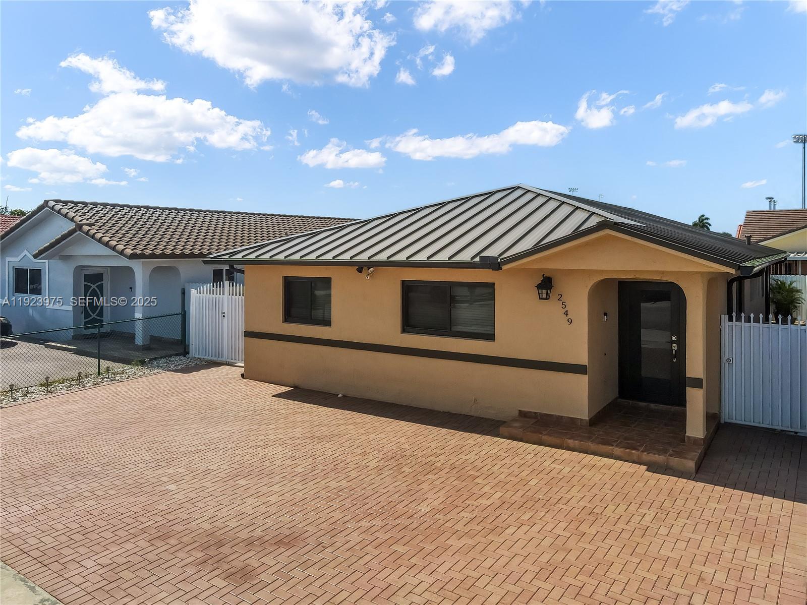 2549 West 72nd Place Hialeah, FL 33016 - Photo 2 of 46 a front view of a house with a yard