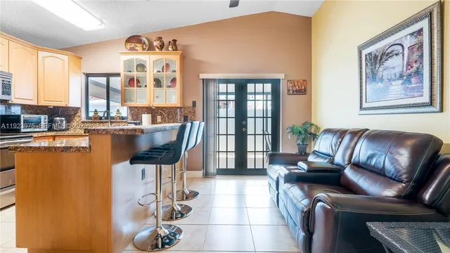a kitchen with stainless steel appliances granite countertop a stove and cabinets
