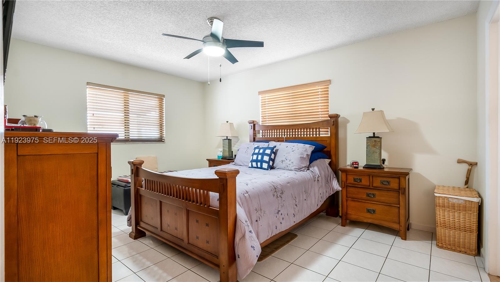 2549 West 72nd Place Hialeah, FL 33016 - Photo 34 of 46 a bedroom with a bed and a chandelier