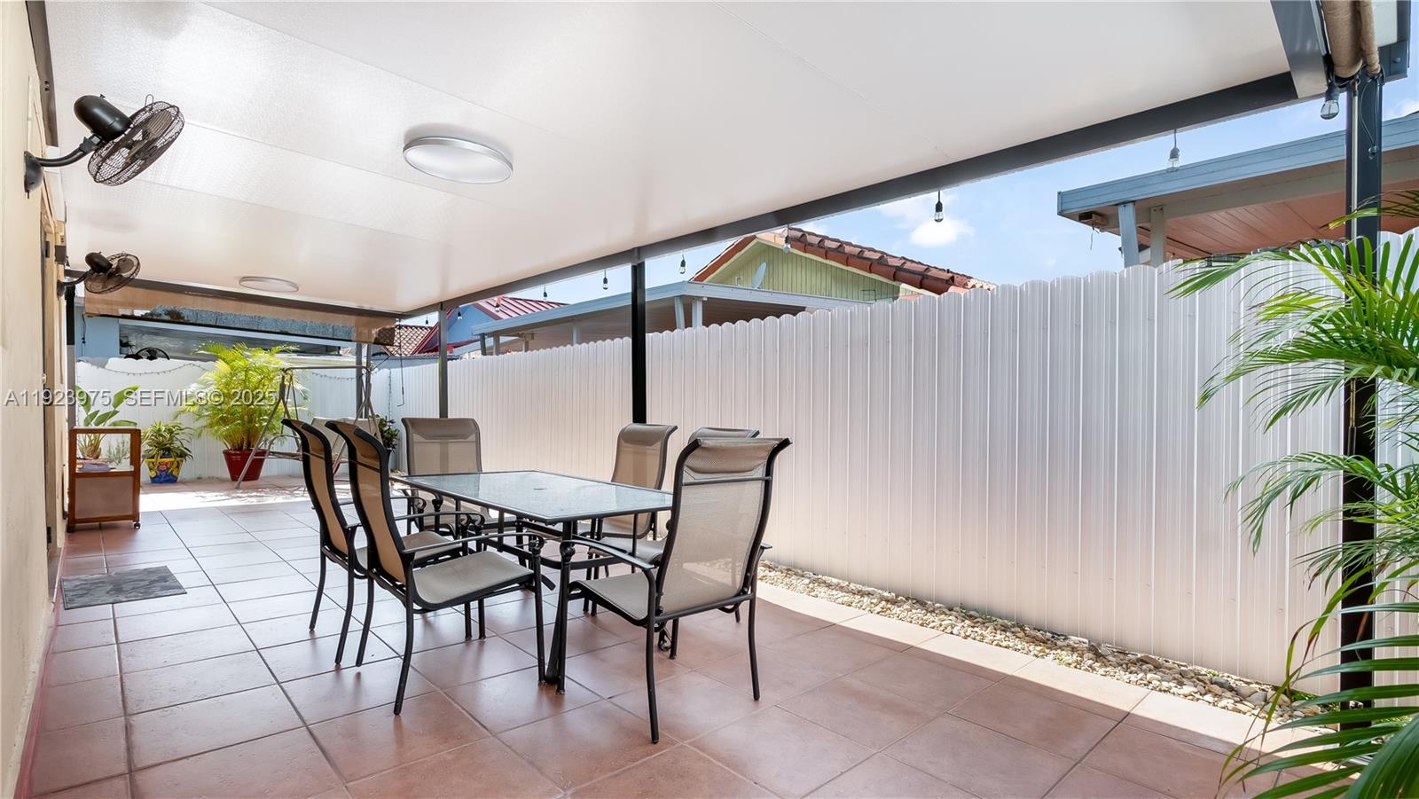 2549 West 72nd Place Hialeah, FL 33016 - Photo 39 of 46 a dining room with furniture and a potted plant