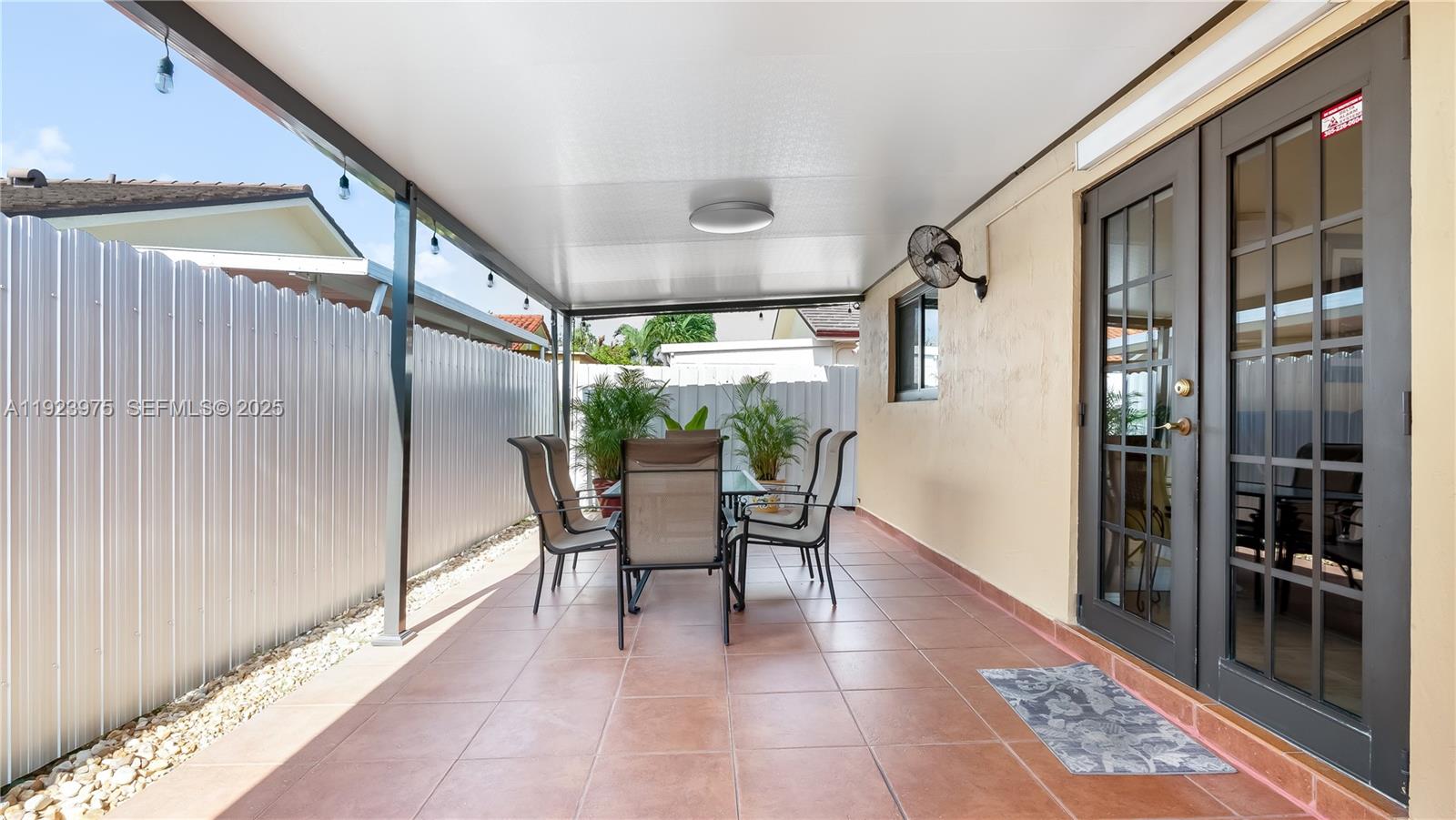 2549 West 72nd Place Hialeah, FL 33016 - Photo 41 of 46 a view of a porch with chairs and floor to ceiling window