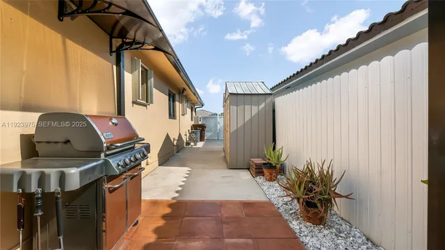 a view of a hallway with white walls and stairs