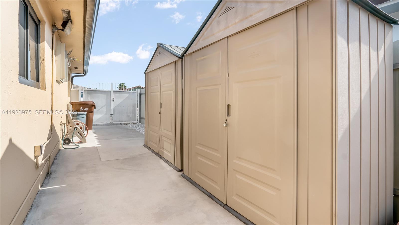 2549 West 72nd Place Hialeah, FL 33016 - Photo 45 of 46 a view of a hallway with white walls and stairs