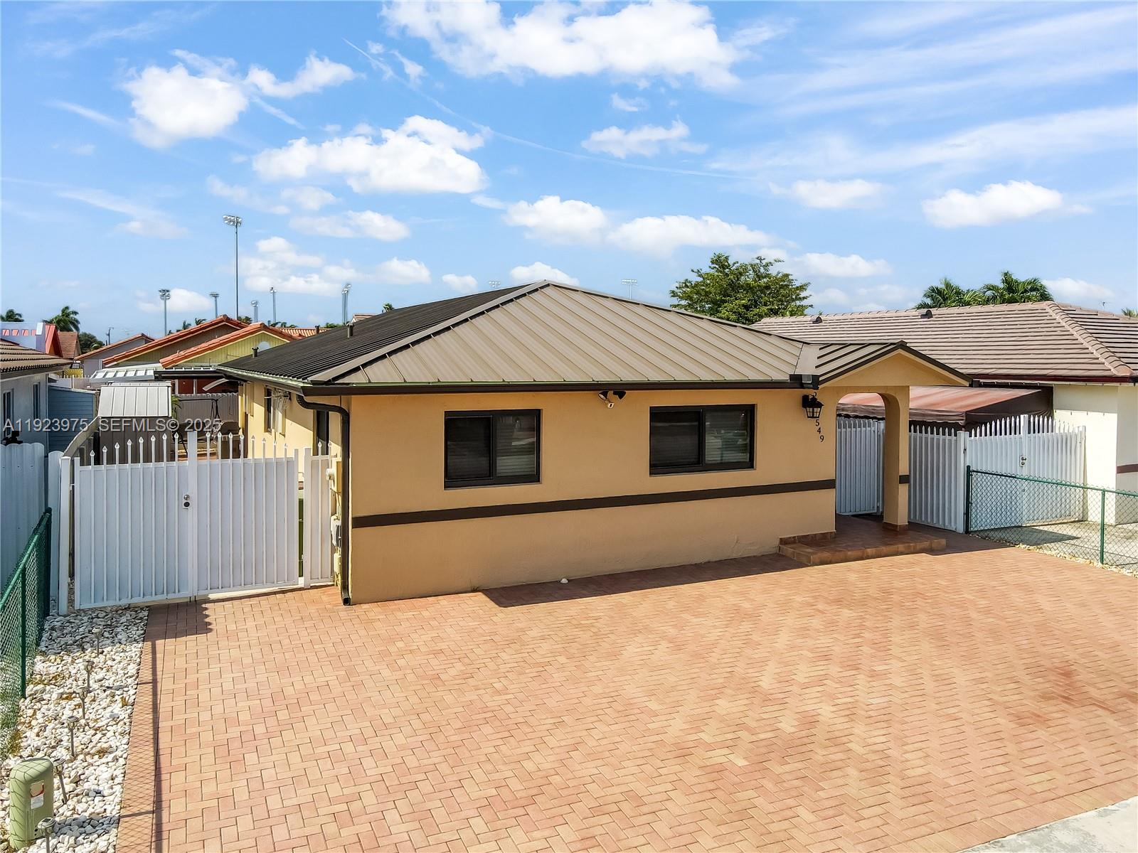 2549 West 72nd Place Hialeah, FL 33016 - Photo 5 of 46 a front view of a house with a yard and garage