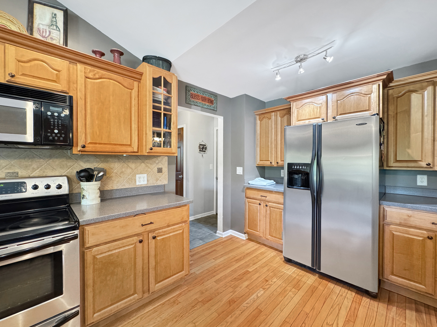 1063 Deer Valley Drive Varna, IL 61375 - Photo 11 of 87 a kitchen with stainless steel appliances granite countertop a refrigerator a stove top oven and sink