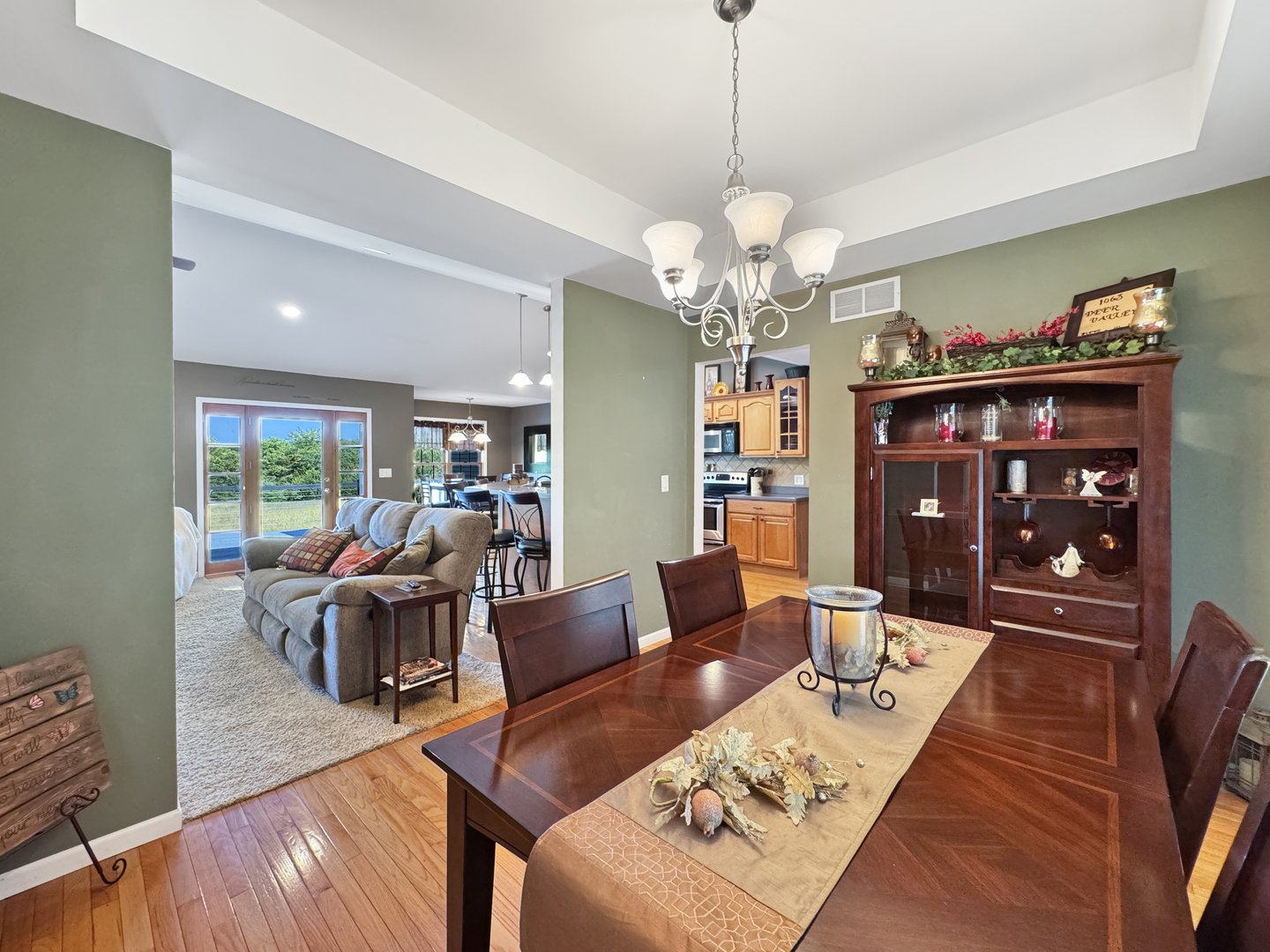 1063 Deer Valley Drive Varna, IL 61375 - Photo 18 of 87 a living room with furniture dining table a rug and a chandelier