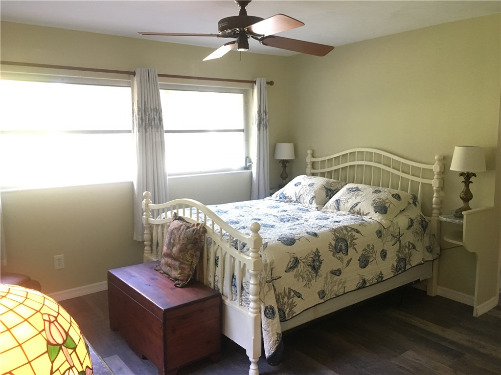 9605 Riverview Drive Micco, FL 32976 - Photo 14 of 36 a bed sitting in a bedroom next to a window