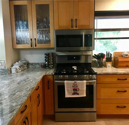 a kitchen with sink a window and cabinets