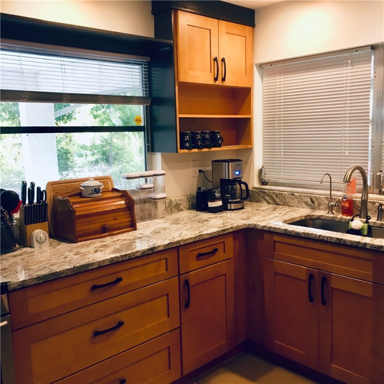 9605 Riverview Drive Micco, FL 32976 - Photo 19 of 36 a kitchen with sink a window and cabinets