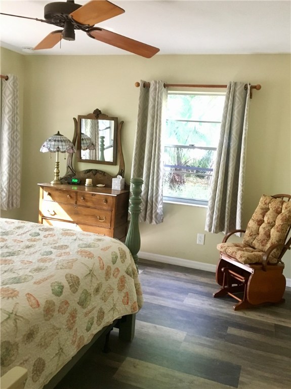 9605 Riverview Drive Micco, FL 32976 - Photo 5 of 36 a bedroom with a bed a chandelier and dresser