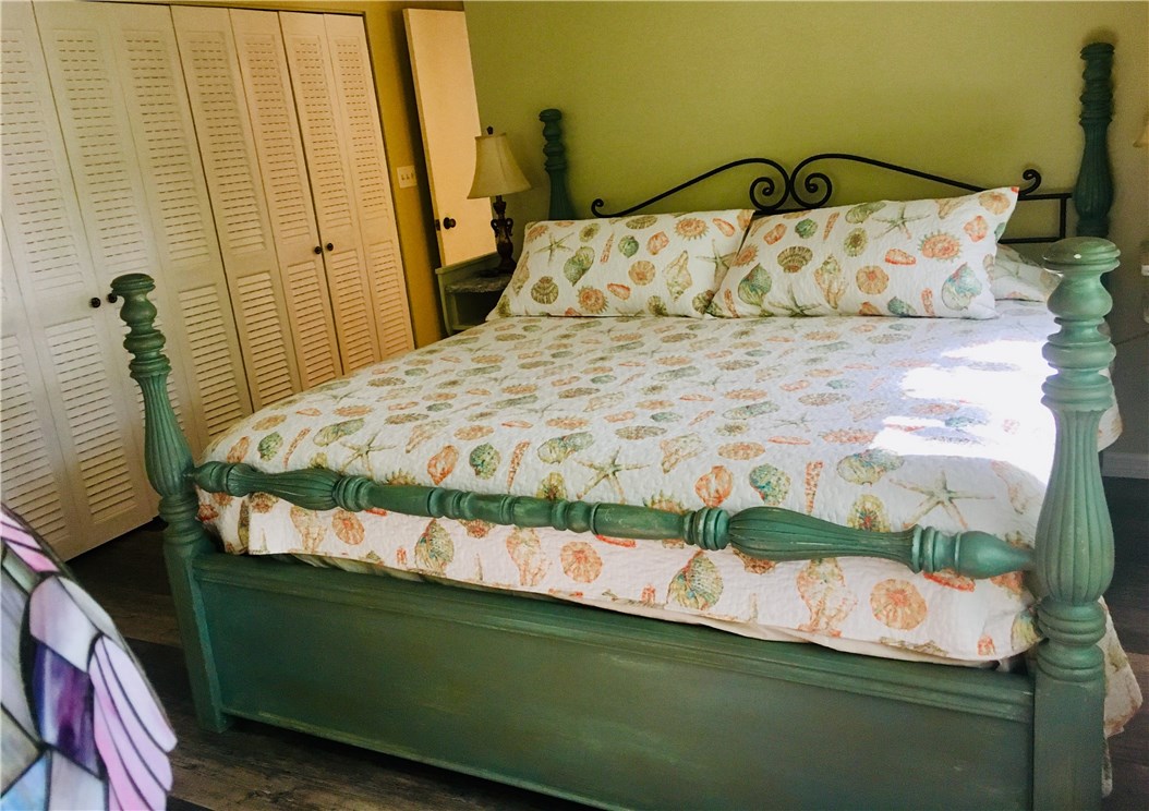 9605 Riverview Drive Micco, FL 32976 - Photo 7 of 36 a bedroom with a bed and wooden floor