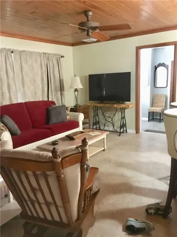 a room with a table chairs and a kitchen view