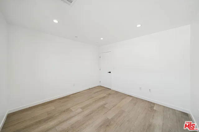 an empty room with wooden floor