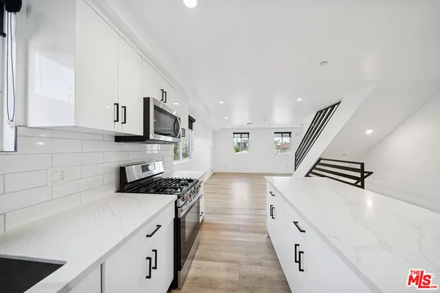 a kitchen with granite countertop a stove and a sink
