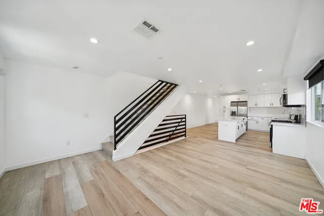 a view of kitchen with furniture and wooden floor