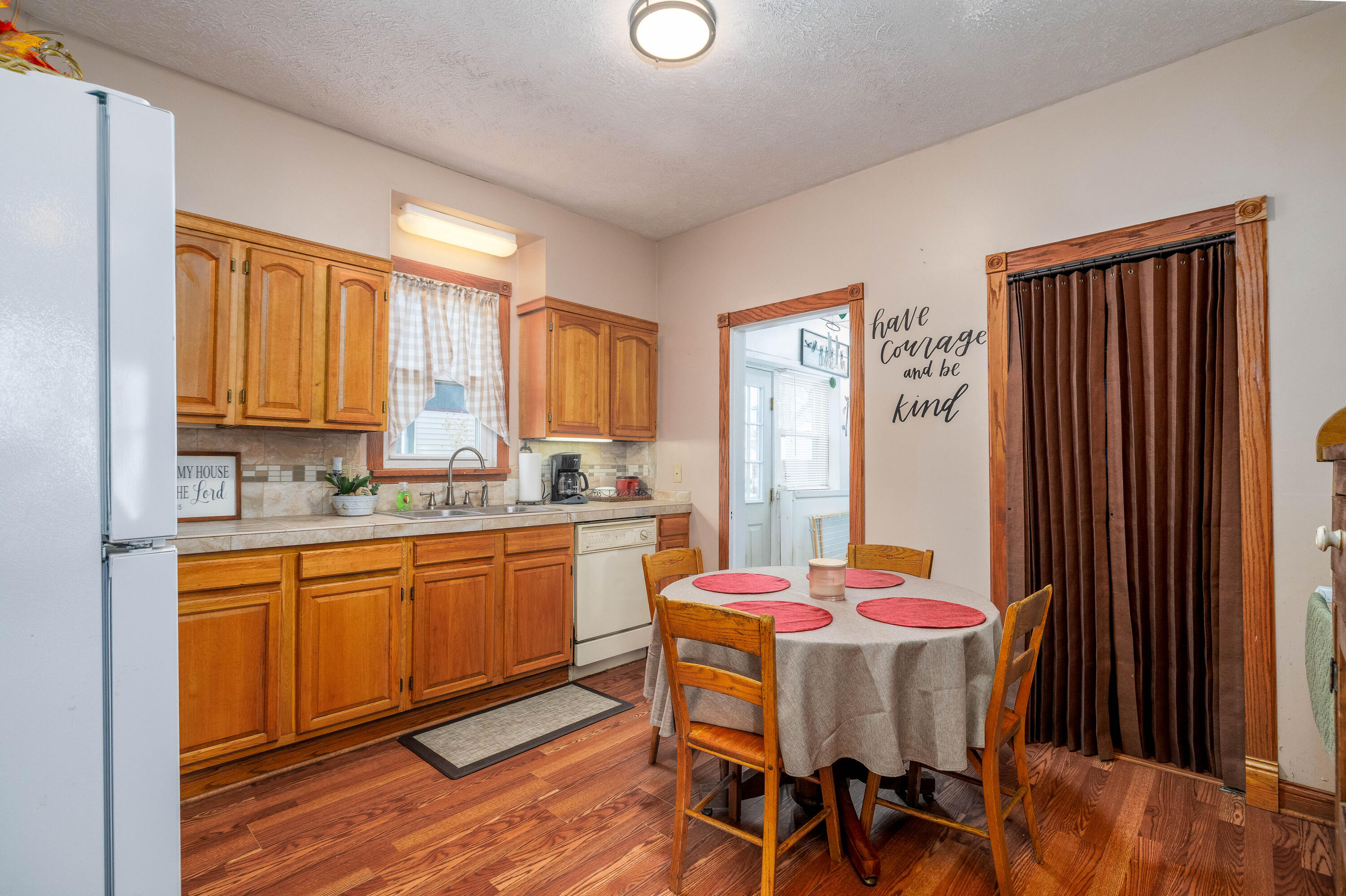 521 North McKinley Avenue Rensselaer, IN 47978 - Photo 20 of 38 a kitchen with stainless steel appliances granite countertop a dining table chairs and a refrigerator