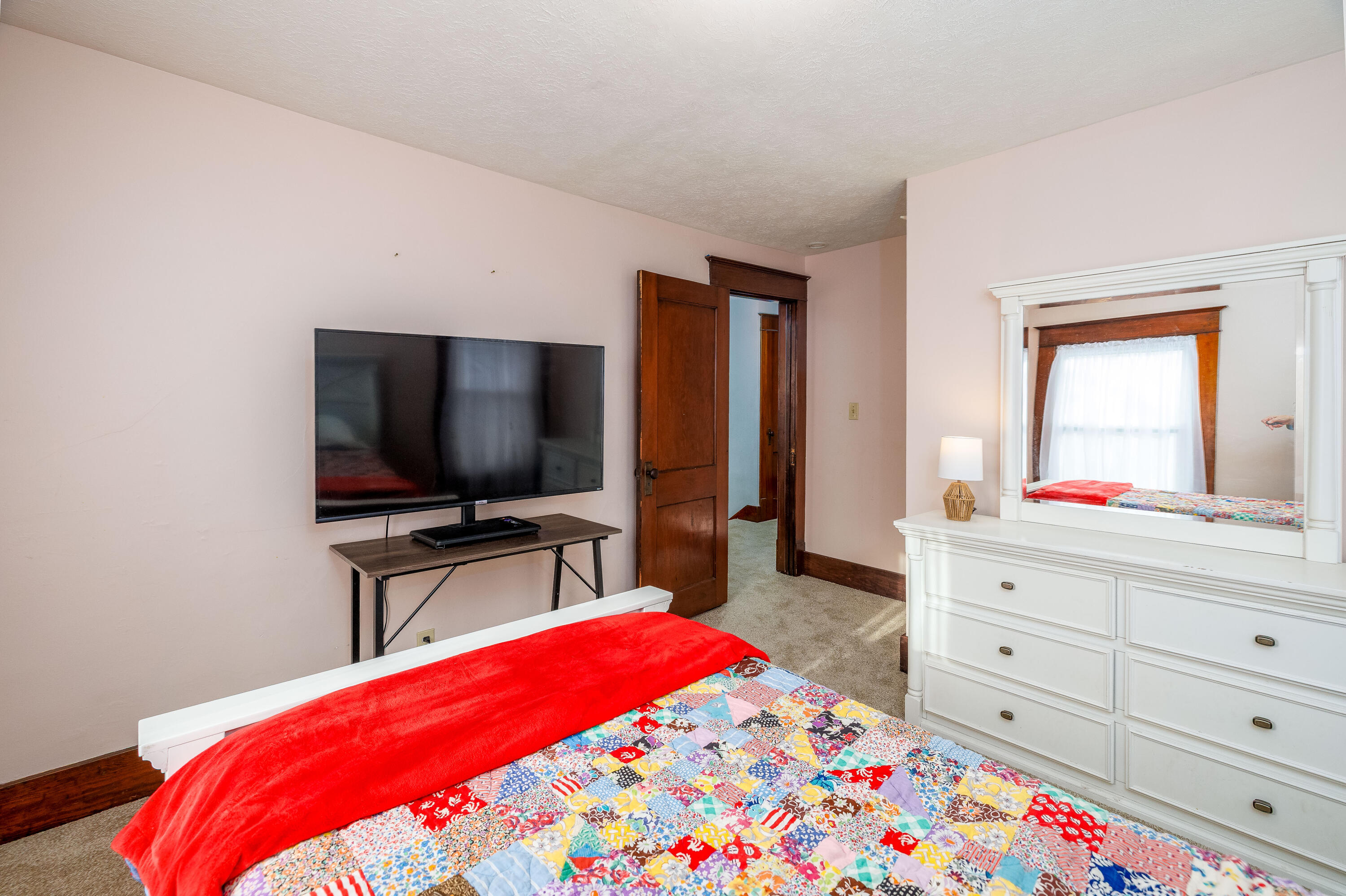 521 North McKinley Avenue Rensselaer, IN 47978 - Photo 29 of 38 a bedroom with a bed and a flat screen tv in a dresser
