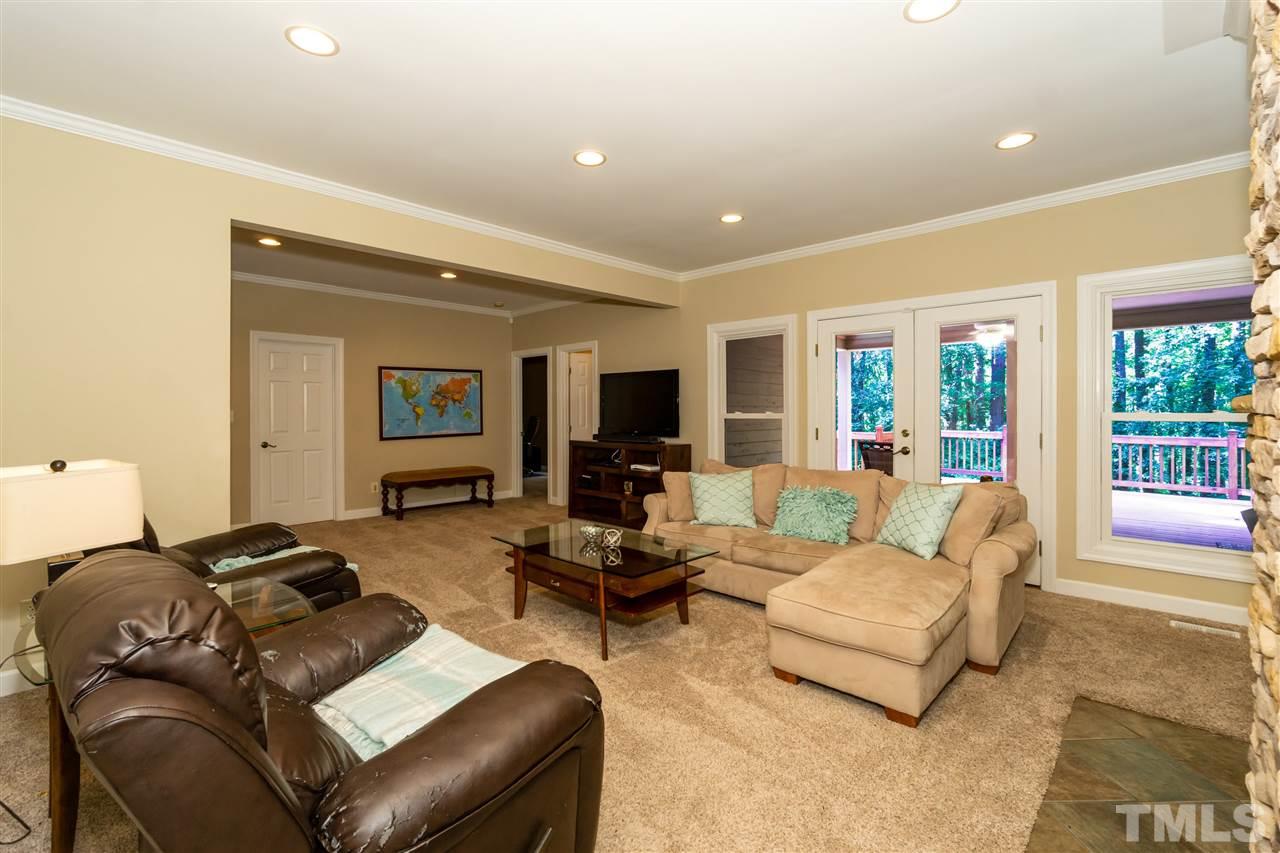 712 Misty Isle Place Raleigh, NC 27615 - Photo 12 of 30 a living room with furniture or couch and a flat screen tv